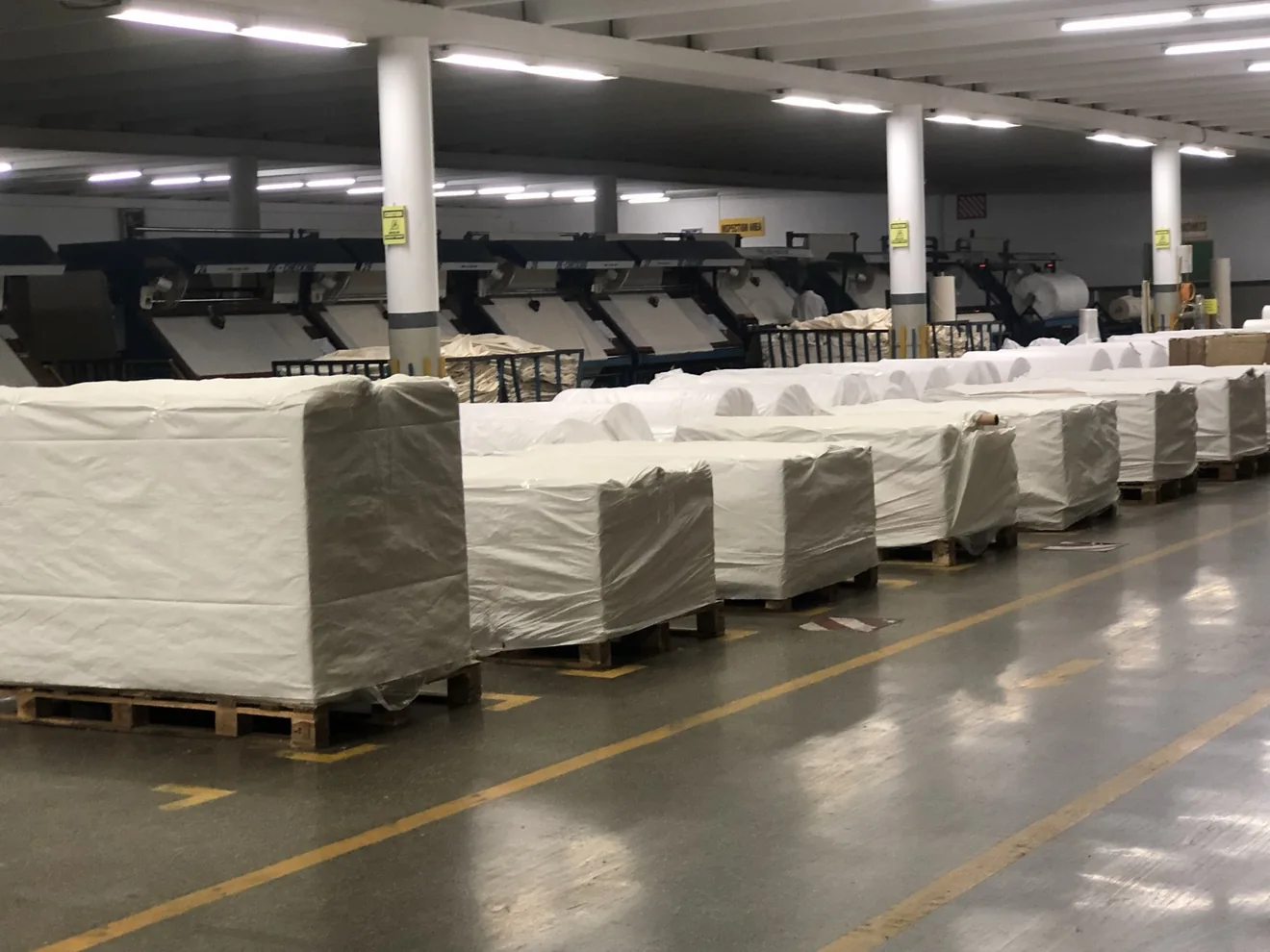 Palletized fabric packing and inspection area within a selected supplier mill